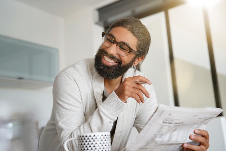 Man Reads A Document Wearing Glasses