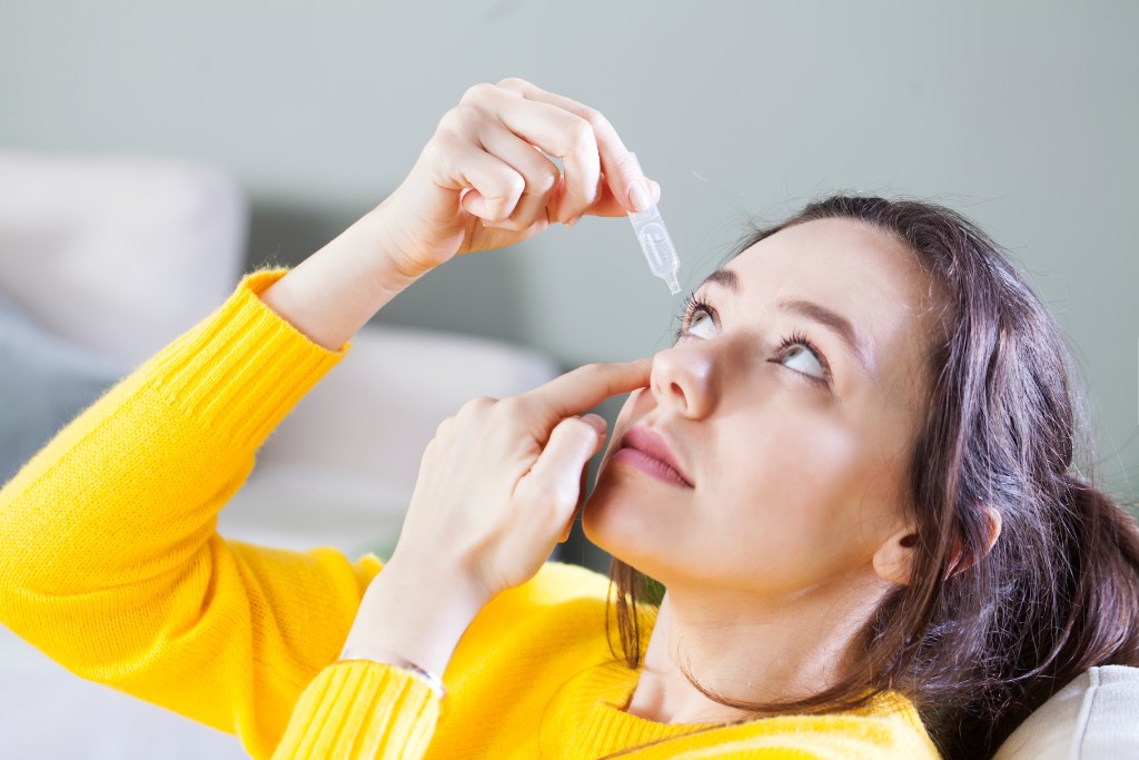 Girl Puts Eye Drop In The Eye